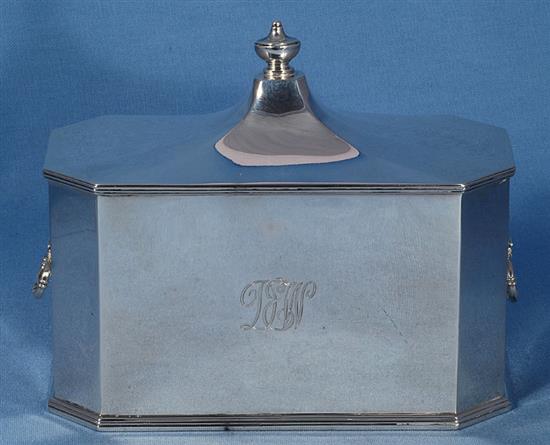 A George V silver two handled octagonal tea caddy, by Richard Comyns, length 202mm, weight 27.1oz/845grms.